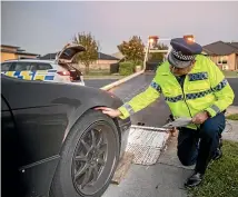  ?? PHOTOS: CHRISTEL YARDLEY/STUFF ?? Waikato road policing manager Inspector Jeff Penno checks out an impounded car.