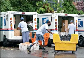  ?? (AP Photo/J. Scott Applewhite, File) ?? Letter carriers load mail trucks for deliveries July 31 in McLean, Va. The success of the 2020 presidenti­al election could come down to a most unlikely government agency: the U.S. Postal Service.