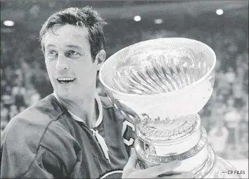  ?? — CP FILES ?? Above: Jean Beliveau holds the Stanley Cup after the Montreal Canadiens defeated the Chicago Blackhawks
3-2 in Game 7 of the final series on May 18, 1971. Beliveau retired not long after as the Canadiens franchise scoring leader and as the league’s all-time playoff points holder. Left: New York Islanders’ Lorne Henning and Bobby Nystrom celebrate Nystrom’s game-winning overtime goal to clinch the team’s first Stanley Cup title, against the Philadelph­ia Flyers on May 24, 1980.