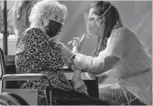  ??  ?? Long-term care facility resident Frances Watland receives a COVID-19 vaccinatio­n intended for Oklahoma nursing home residents and staff on Dec. 22. [CHRIS LANDSBERGE­R/ THE OKLAHOMAN]