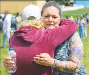  ?? STAFF PHOTO BY TIFFANY WATSON ?? Monique Pierre, a Calvert County resident, gets a hug during the second annual Tri-County Memory Walk on Saturday as she remembered her fiancee, Douglas Beazley, who died from a drug overdose on June 17, 2015.