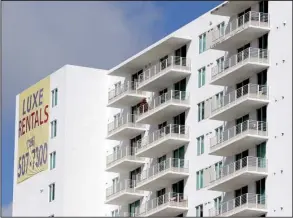  ?? AP/LYNNE SLADKY ?? Newly built apartments are advertised for rent in downtown Miami in February. Rent costs are starting to level off, real estate figures show.