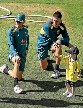 ??  ?? Austin Marsh, son of Australian batsman Shaun Marsh, points the way to Tim Paine, left, and Mitchell Marsh at the MCG yesterday. GETTY IMAGES