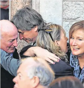  ??  ?? Mourning: Family members are consoled; (inset left) Louis Walsh pays his respects and (below) John Reynolds, who passed away last Thursday