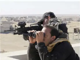  ??  ?? RAMADI: Soldiers of Iraq’s anti-terrorism force watch movements during a military operation to regain control of the western suburbs of the capital of Iraq’s Anbar province, 115 km west of Baghdad on Saturday. — AP