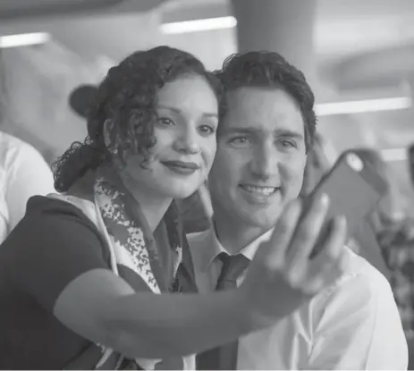  ?? PAUL CHIASSON/THE CANADIAN PRESS ?? Liberal Leader Justin Trudeau poses for a selfie with a student at Mohawk College Wednesday. Trudeau now says a majority government is in sight.