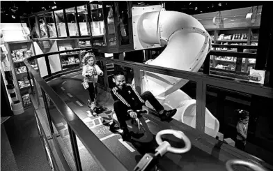  ?? MARK LENNIHAN/AP ?? Children try out scooters on an elevated loop at the Camp toy store in New York.