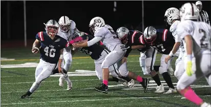  ??  ?? Lincoln running back Tyler Dusty (40) attempts to break a big run in the first half of the Lions’ 46-21 Division II defeat to East Greenwich Friday night at Ferguson Field.