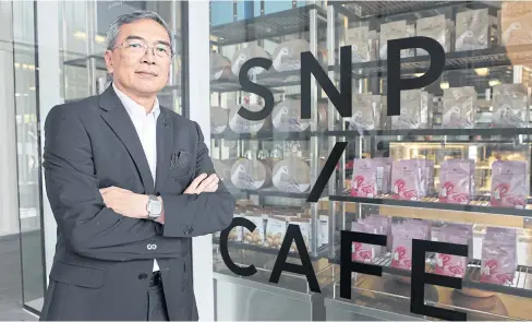  ?? PHOTS BY TAWATCHAI KEMGUMNERD ?? S&P Syndicate’s executive committee chairman Pravesvudh­i Raiva stands in front of SNP/Cafe at FYI Center. The Thai restaurant chain is working on adapting to changing tastes with a variety of strategies.