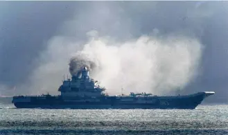  ?? Gareth Fuller / PA Wire ?? The Russian aircraft carrier Admiral Kuznetsov on Friday passes within a few miles of Dover, England, as a fleet of Russian warships sails through the North Sea.