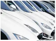  ?? DAVID ZALUBOWSKI/AP ?? A long row of unsold 2020 Model S sedans sits at a Tesla dealership in Littleton, Colorado.