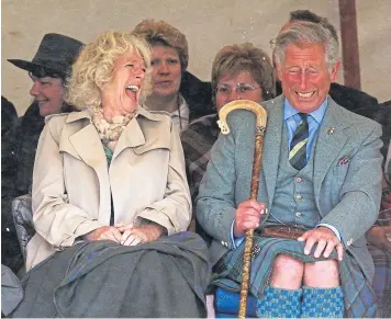  ??  ?? Somebody has said something very amusing. Prince Charles and Camilla attending a highland games. Could it be Braemar?