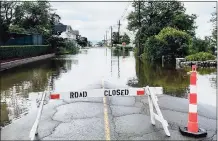  ?? Sarah Kyrcz / For Hearst Connecticu­t Media ?? Floodwater covers a road in Madison on Thursday after heavy rain passed through the area.