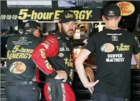  ?? PAUL SANCYA — THE ASSOCIATED PRESS ?? Martin Truex Jr. watches his crew work during practice for a NASCAR Cup Series auto race at Michigan Internatio­nal Speedway in Brooklyn, Mich., Saturday.