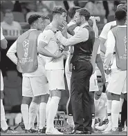  ?? AP/REBECCA BLACKWELL ?? England Coach Gareth Southgate (right) talks to John Stones during their team’s 2-1 World Cup semifinal loss to Croatia on Wednesday. England meets Belgium today in the third-place game.