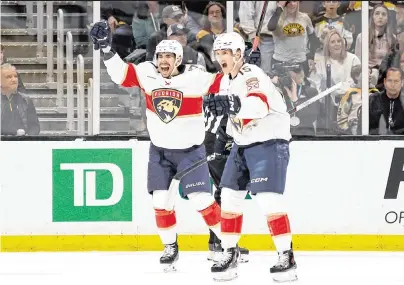  ?? WINSLOW TOWNSON USA TODAY Sports ?? Panthers center Evan Rodrigues, left, celebrates his first period goal with Anton Lundell against the Bruins in Game 3 of their second-round series Friday night in Boston. Rodrigues would add a second goal late in the third period.