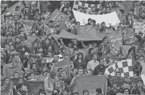  ?? VAHID SALEMI/ASSOCIATED PRESS, FILE ?? Supporters of Iranian soccer team Esteghlal, hold flags of their favorite team, at the Azadi stadium in Tehran, Iran. Sahar Khodayari, an Iranian female soccer fan died after setting herself on fire Tuesday outside a court after learning she may have to serve a six-month sentence for trying to enter a soccer stadium where women are banned.