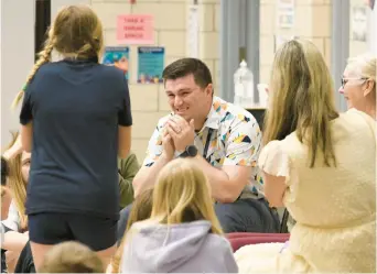  ?? PAUL W. GILLESPIE/STAFF PHOTOS ?? Fifth grade teacher Bradley Absher reacts Thursday to being announced the award winner of a surprise $25,000 Milken Educator Award during an assembly at the school.