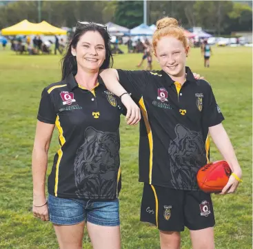  ?? Picture: BRENDAN RADKE ?? CAN’T WAIT: Looking forward to the AFL season opener at Cazalys on Saturday are North Cairns Tigers juniors supporter Lauren Tanis and junior player Lauren Davon.