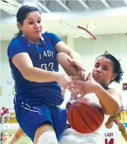  ?? CLYDE MUELLER/THE NEW MEXICAN ?? St. Michael’s Danielle Vigil, left, battles Las Vegas Robertson’s Jazmyne Jenkins for a rebound Friday in a Class 4A State Tournament game in Las Vegas, N.M. The No. 3 seed Lady Cardinals won 51-36 over the No. 14 Lady Horsemen.