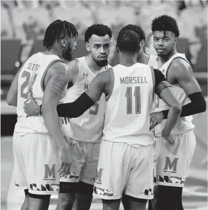  ?? JULIO CORTEZ/AP ?? Maryland players from left, Donta Scott, Eric Ayala, Darryl Morsell, Aaron Wiggins and Hakim Hart huddle against Michigan State during a game Feb. 28 in College Park.