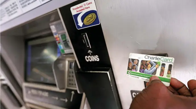  ?? MATT STONE PHOTOS / HERALD STAFF ?? SOFTWARE BEWARE: A passenger checks his Charlie Card at a machine at the Government Center MBTA station on Friday. The ticket machines run Windows XP, which Microsoft stopped supporting several years ago.