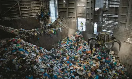  ?? ODED BALILTY/AP ?? Waste largely made up of plastic is gathered Jan. 25 at a recycling plant near Jerusalem. Israel’s tax on single-use plastic items may end soon.