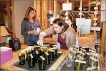  ?? COURTNEY KUEPPERS / COURTNEY.KUEPPERS@AJC.COM ?? Erica Brown began making candles in wine bottles as a hobby in 2015. In years since, she and her mom, Sabrina Watson, have scaled it into a business, Corked Candles.