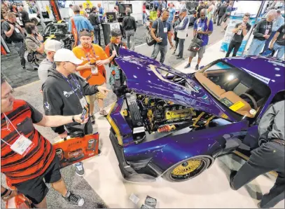  ?? K.M. Cannon Las Vegas Review-journal ?? Convention­eers check out the BASF Automotive Refinish Coatings booth at the 2018 Specialty Equipment Market Show at the Las Vegas Convention Center. This year’s SEMA Show has been canceled because of COVID-19.