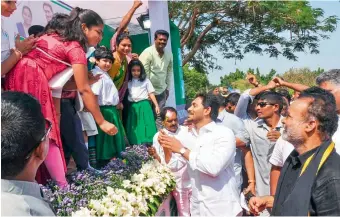  ??  ?? School students present flowers to AP Chief Minister Y.S. Jagan Mohan Reddy on his arrival at PVKN Grounds in Chittoor where he launched the Jagananna Amma Vodi scheme on Thursday.