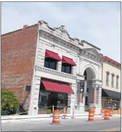  ?? (Courtesy Photo/James Hales) ?? Constructi­on of the Railyard Park is underway in downtown Rogers, but the Applegate Drug Store and Bank of Rogers buildings are original and just as beautiful as when built in 1907.