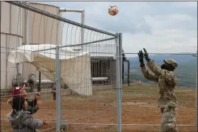  ?? (AP/U.S. Army/Capt. Mikel Arcovitch) ?? Army Pfc. Rafiou Affoh plays volleyball with Afghan evacuees earlier this month at Camp Liya, Kosovo.