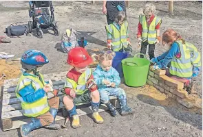  ?? ?? Taking a break – one youngster even had his own hard hat.