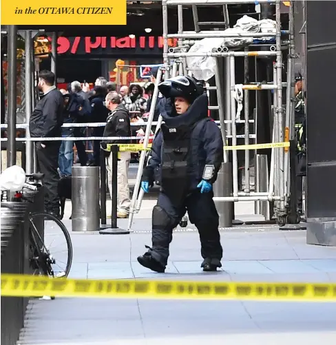  ?? TIMOTHY A. CLARY / AFP / GETTY IMAGES ?? A bomb squad officer exits the Time Warner Building in New York Wednesday, where a “live explosive device” was found in CNN’s New York bureau, prompting an on-air evacuation of the building. The device was linked to bombs sent to the Clintons, Obamas and liberal donor George Soros.