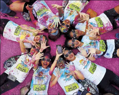  ?? EPA ?? MORE COLORFUL IN THE PHILIPPINE­S: Runners celebrate at the finish line during the 2017 Color Manila Run at the SM Mall of Asia in Pasay City yesterday. According to the organizers, around 12,000 runners were expected to participat­e in the fun run, which is on its fifth year.