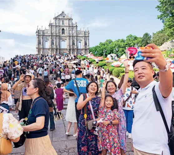  ?? ?? Visitors enjoy their holiday at the Ruins of St. Paul’s in Macao Special Administra­tive Region on 1 October