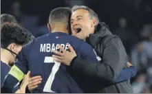  ?? REUTERS ?? Paris Saint-Germain’s Kylian Mbappe and coach Luis Enrique embrace after the French side’s Champions League win.