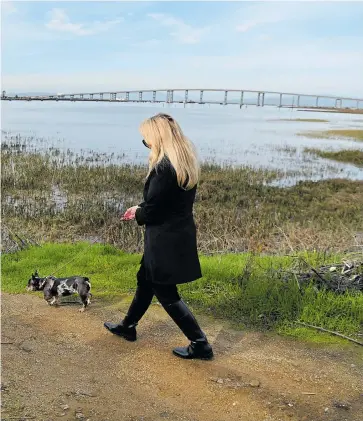  ?? JOSE CARLOS FAJARDO/ STAFF ?? A stroll along Vallejo’s stretch of the Bay Trail is just the thing for Diablo resident Brenda Benson and her granddaugh­ter, Kataleya Garitano, 6, and dog, Boba.