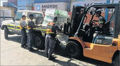  ??  ?? BIG HAUL: Police confiscate more than R1-million worth of goods at the Port Elizabeth harbour