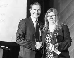  ??  ?? Peter Forrester, left, of Kinder Morgan Canada Inc.,
accepts the Litigation Management award.