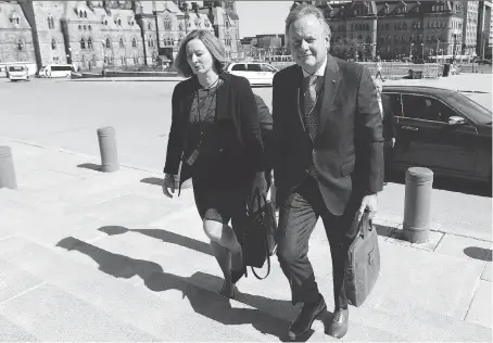  ?? THE CANADIAN PRESS/JUSTIN TANG ?? Governor of the Bank of Canada, Stephen Poloz, and Senior Deputy Governor Carolyn Wilkins arrive on Parliament Hill in April. If increased protection­ist measures result in higher prices, the central bank will be duty bound to stop the spread of inflation.