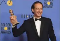  ??  ?? Composer Alexandre Desplat poses with his award for Best Original Score Motion Picture for ‘The Shape of Water’.