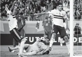  ?? Jim Watson / AFP/Getty Images ?? Mexico’s Raul Jimenez, right, scores against Martinique during their match in the group stage at Bank of America Stadium in Charlotte, N.C.