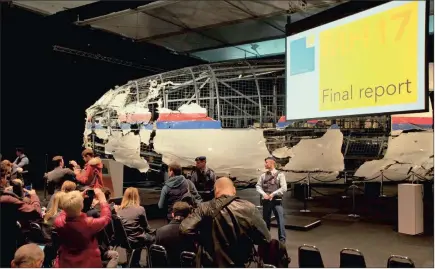  ?? PICTURE: AP ?? Part of the reconstruc­ted Malaysia Airlines Flight 17 plane is seen at a press conference in Cilze-Rijen, in The Netherland­s, yesterday before the presentati­on of the Dutch Safety Board final report into what caused the aircraft to break up high over...