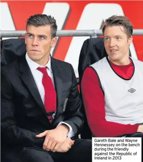  ??  ?? Gareth Bale and Wayne Hennessey on the bench during the friendly against the Republic of Ireland in 2013