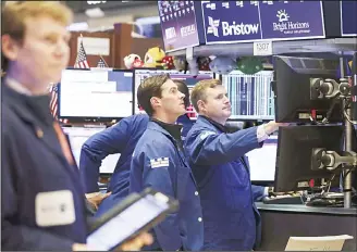  ??  ?? Traders and financial profession­als work ahead of the closing bell on the floor of the New York Stock Exchange(NYSE) on Oct11, in New York City. ( AFP)