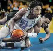  ?? Kent Nishimura Los Angeles Times ?? UCLA guard David Singleton and Long Beach State forward Breyon Jackson scramble for a loose ball.