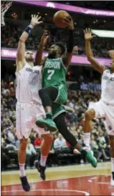  ?? PABLO MARTINEZ MONSIVAIS — THE ASSOCIATED PRESS ?? Boston’s Jaylen Brown (7) drives past Washington’s Marcin Gortat (13) and Bradley Beal (3) during the second half Thursday in Washington.