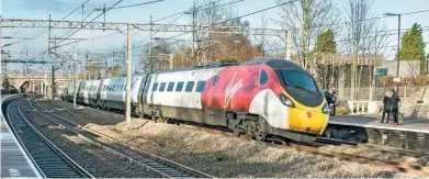  ?? JOHN STRETTON. ?? Resplenden­t in the latest Virgin Trains livery, 390009 races through Lichfield Trent Valley on its way to Euston on December 20 2018. According to Labour, VT’s fare rises on its Birmingham-London route since 2010 are the largest in absolute prices.