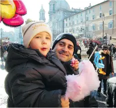  ??  ?? Families enjoy Piazza Navona’s Christmas market, which is home to vivid displays, performers and food. Rome is a particular­ly joyful place to celebrate the holidays, a month-long affair that ends on Jan. 6.